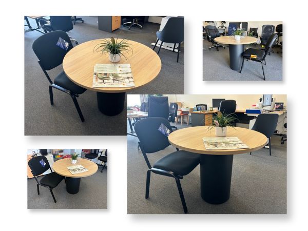 A sleek round Drum Base Meeting Table with four stackable Venus Visitor Chairs. The table is 1200mm in diameter with a modern black or white base, paired with comfortable fabric chairs available in black or blue. Ideal for small meeting spaces or crib rooms.